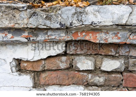 
The texture of bricks and plasters, dilapidated and destroyed