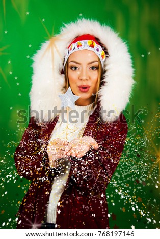 Beautiful girl in winter clothes smiling holiday christmas concept celebration taking pictures posing and sending kisses