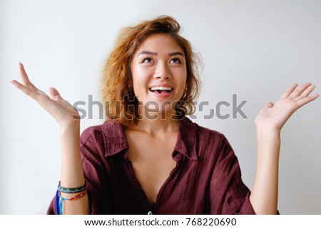 Portrait of happy woman with worshipping gesture
