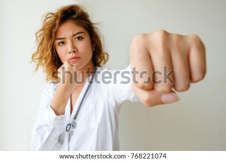 Portrait of angry general practitioner boxing