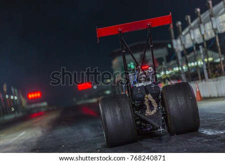 Dragster race car down the race track, Dragster racing car in preparation for the qualifying run. Royalty-Free Stock Photo #768240871