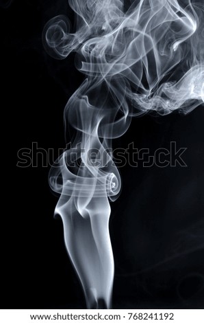 artistic smoke spreading around black background looks mystic