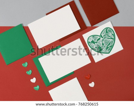 Red green white mock-up layout of stationery, a template for brand identification on blue background. For presentations and portfolio of graphic designers. Envelopes, sheets of paper, hearts.