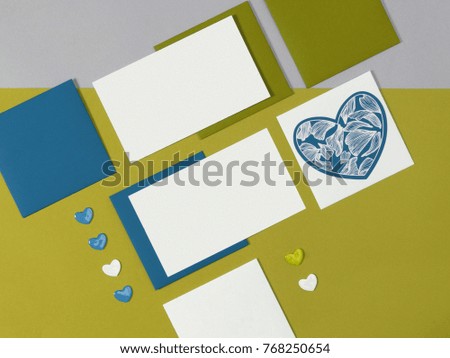 Yellow blue white mock-up layout of stationery, a template for identification on a gray and blue background. For presentations, portfolio of graphic designers. Envelopes, sheets of paper hearts.