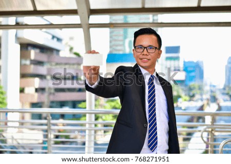 Business Concept, Young businessman is showing his business card.