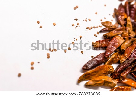 Lot of dried chili as a food background. Red chili pepper dried. Free space for text . Top view. sun dried chili flakes and seeds pile isolated on white background. Cayenne pepper or paprika