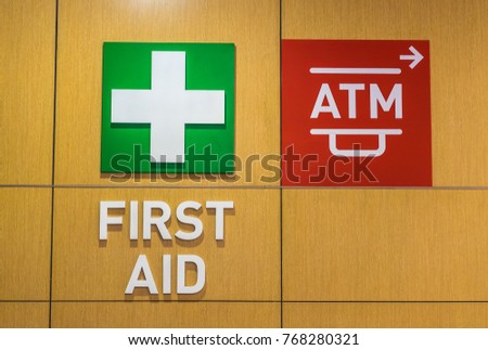 First aid and ATM sign.