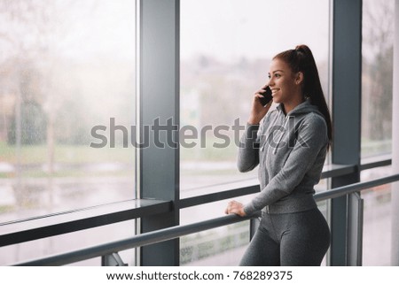 Young fit girl talking on mobile