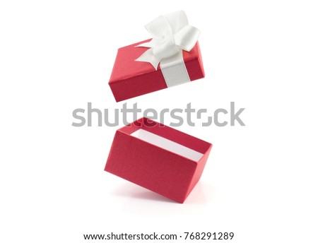 close up open empty red gift box with ribbon bow wrapped lid floating isolated on white background, cardboard box decorated with red paper and bow for put present, surprise in holiday celebration Royalty-Free Stock Photo #768291289