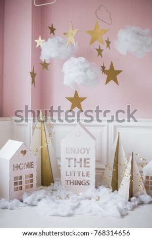 New year decoration. Tiny Christmas houses.Christmas background with white house, snowflakes, star, garlands and decorations. Christmas card