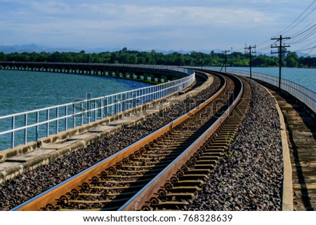 Railroad tracks cross the reservoir at Pasak Dam in , Lopburi, Thailand.Railroad unseen thailand. 
