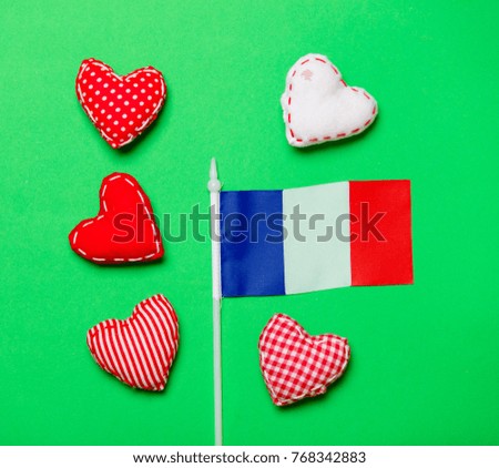 Valentines Day heart shapes and flag of France on green background