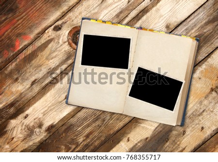 Retro book and vintage photoframes on old wooden planks. Mock up template. Copy space for your text