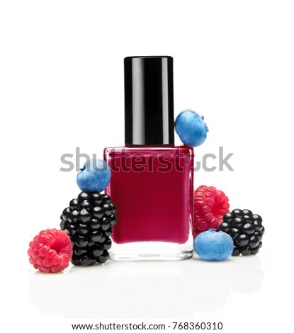 Dark pink nail polish bottle with wild berries(blackberry, blueberry, raspberry) on white background
