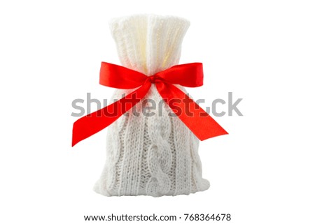 Knitted bag with red ribbon on a white background. Isolated object