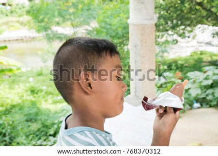 cute asian little boy eating ice cream