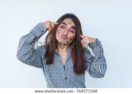 Beautiful asian woman make up face joke on white background,Thailand people pose for take a picture