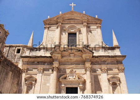 Bottom view of Saint Ignatius Church in Dubrovnik old town with clear blue sky background.