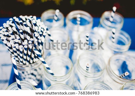 a lot of transparent cans with a striped tube.