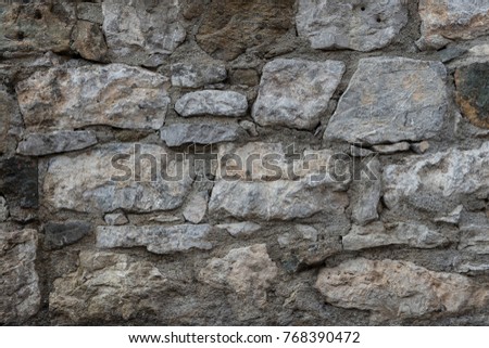 Granite texture, stone wall surface closeup. Grunge cobblestone background, building decoration, vintage decor
