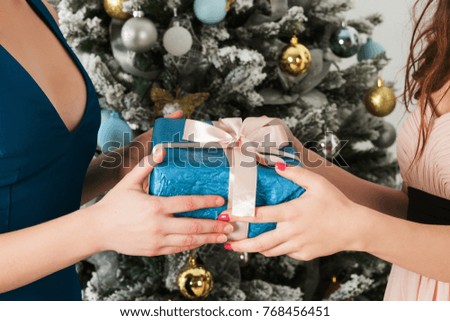 Girl getting excited over christmas gift from her friend