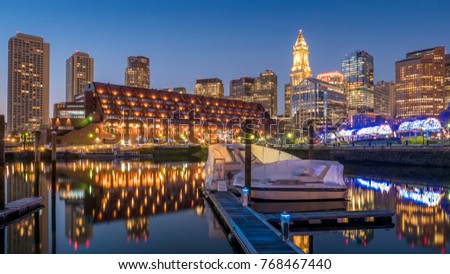 View of the Boston Harbor and Financial District at night showcasing its mix of contemporary and historic architecture.