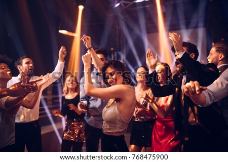 Shot of a young woman dancing in the nightclub Royalty-Free Stock Photo #768475900