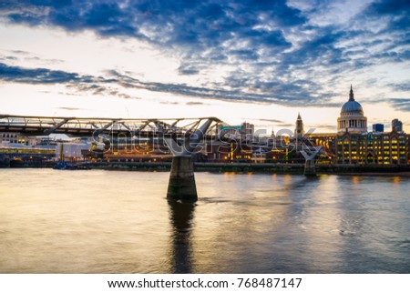 Millenium bridge and St.Paul's cathedral at dusk. London.England