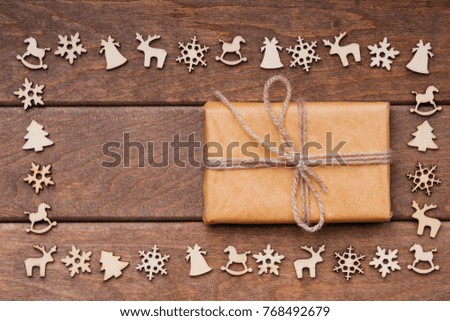 Christmas decoration over wooden background and gift box 