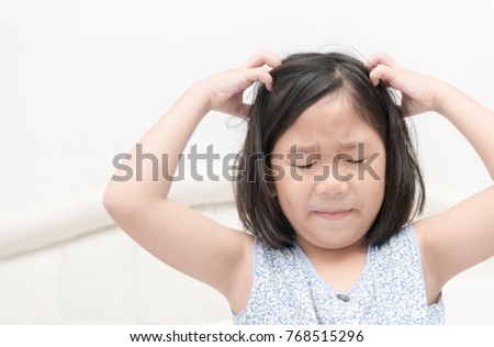 kid with freckles scratching his hair for head lice or allergies, Health care concept
