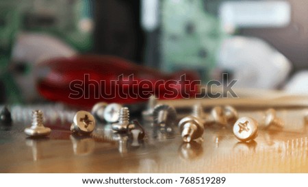Screw and screwdriver for computer repair tools. concept of computer hardware. repairing upgrade and maintenance technology blurred background