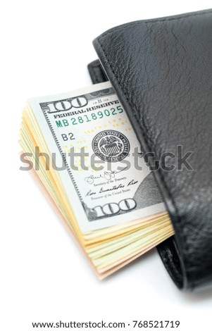 Dollar bills sticking out of black leather wllet