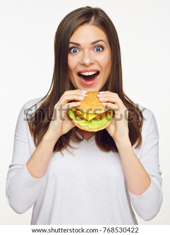Happy girl holding fast food burger. isolated portrait on white background.