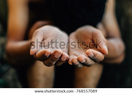 Selective focus. hands poor child begging you for help.children sitting in slum.concept for poverty or hunger people, Human Rights,background text.