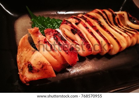 Barbecued whole squid in a tradition family host based Japanese restaurant