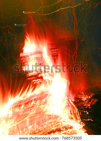 photo of bright flame and Fire Smoke at night. Abstract background texture and pattern.

