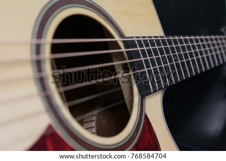 Close up acoustic guitar selected focus on guitar strings 