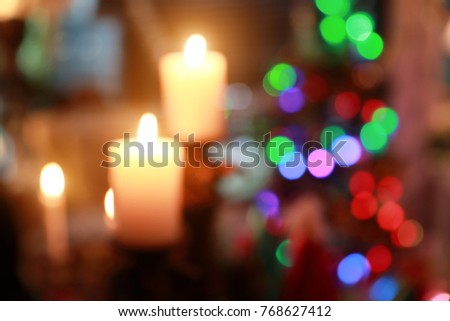 blur image of candle in the dark light with bokeh (christmas party concept)