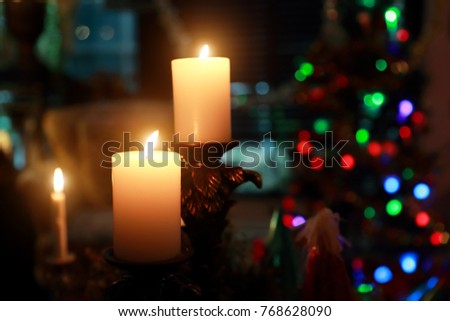image of candle in the dark light with bokeh (christmas party concept)