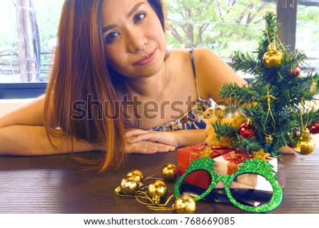 Gifts on the table and background women.                               