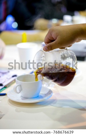 pour coffee, pouring Fresh coffee into the cup