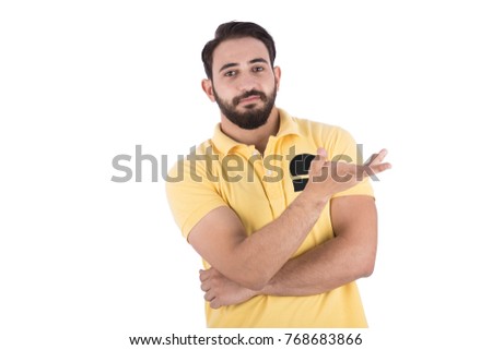 shot of handsome beard man with folded arm and open hand as carrying something to show left side. He is wearing a yellow t-shirt. Isolated on white background.