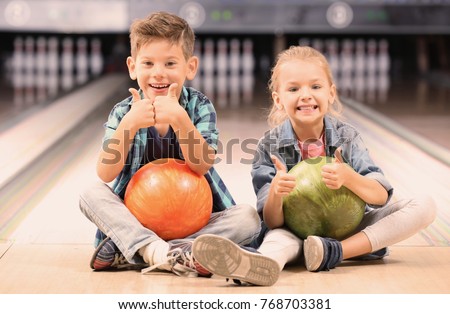 Cute little children at bowling club