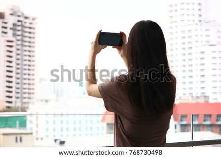 Cute tourist girl take photo business tower.
