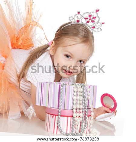 Picture of beautiful little princess girl with a mirror over white