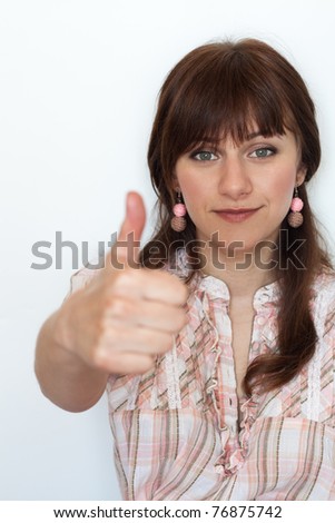 Handsome young woman with thumbs up on an isolated white background