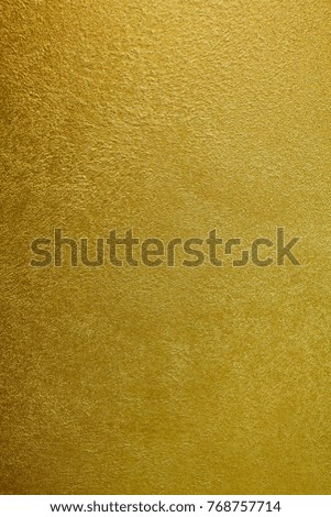 Texture of the painted surface of a granular wall. Brilliant, warm, yellow color. Designer background. Artistic plaster. Rastered digital fit. Realistic photo.