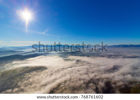 Sunny weather and low level couds over mountains in Beskids area in Poland 