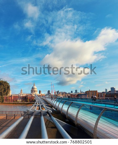 London, panoramic view of Millennium bridge, St. Paul and downtown skyline on a bright day in Fall