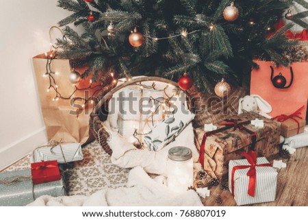 merry christmas and happy new year concept. festive room with christmas tree with lights, space for text. gifts and presents under tree. happy holidays